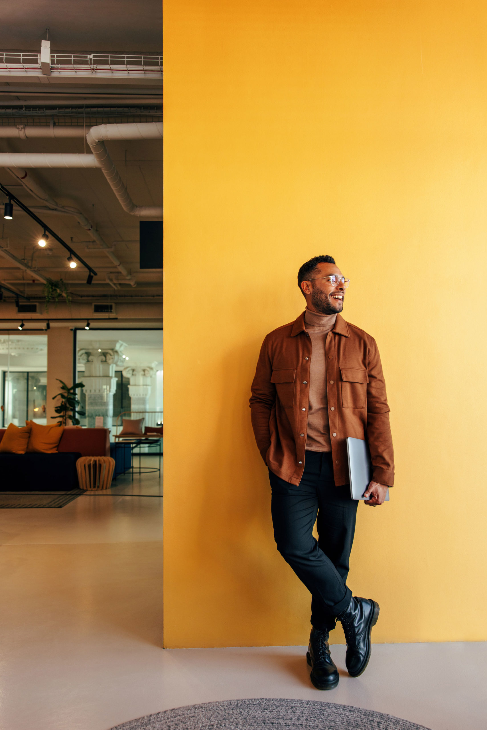 business-man-in-front-of-yellow-wall